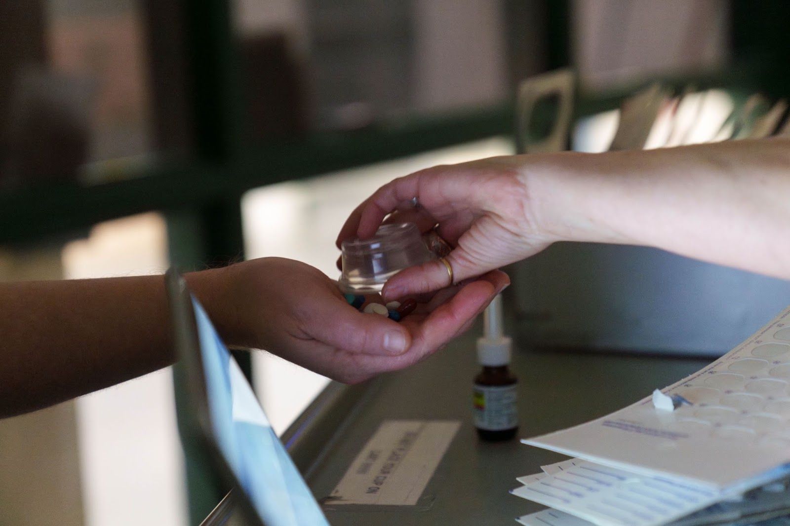 officer handing medication to inmate