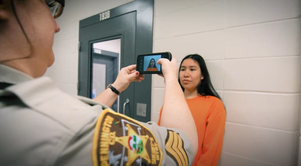 CO taking photo of inmate