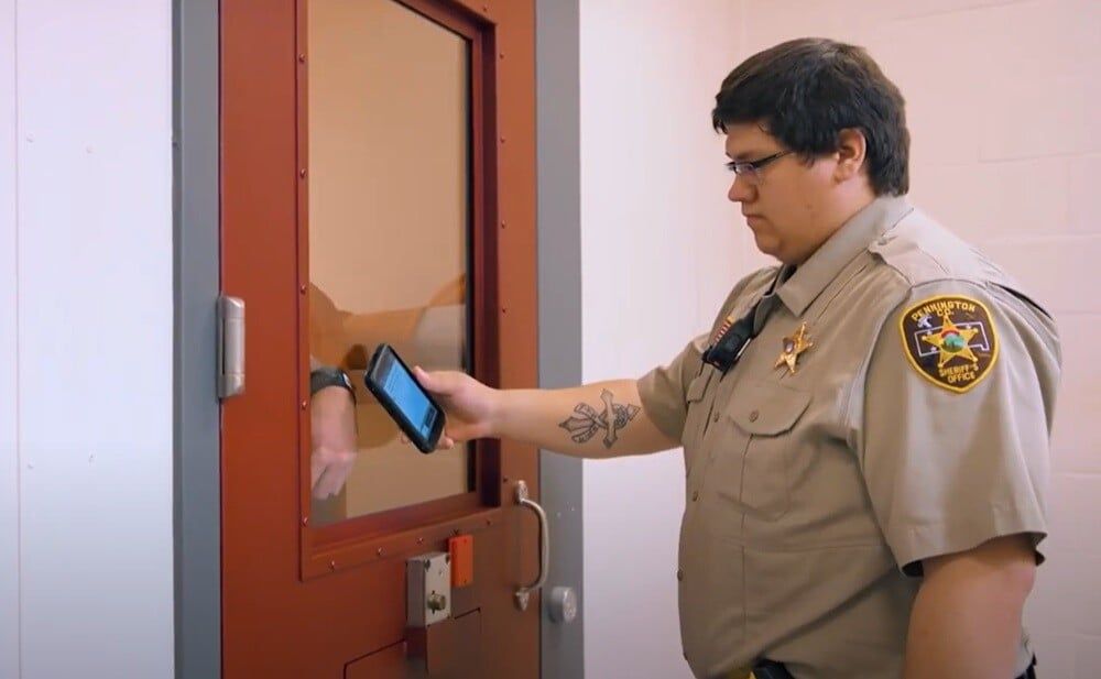 correctional-officer-scanning-inmate-identification-wristband (1)