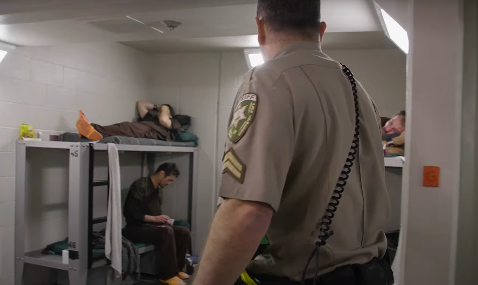 officer checking inmates in cell