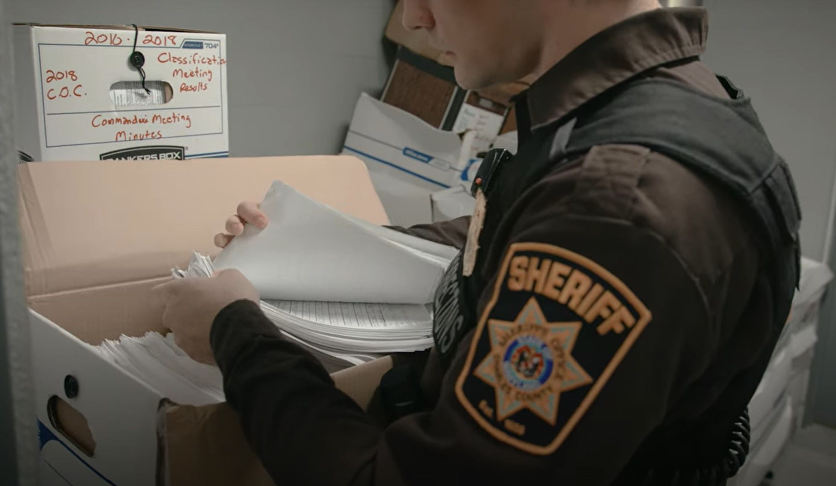 officer sorting paper logs
