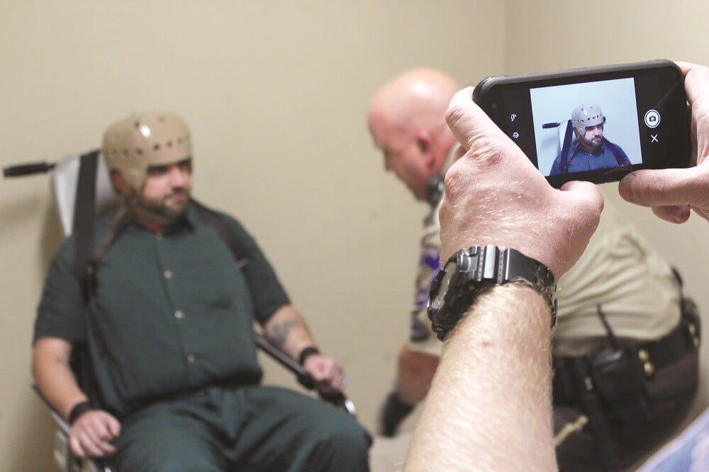 taking image of inmate in restraint chair with SPARTAN