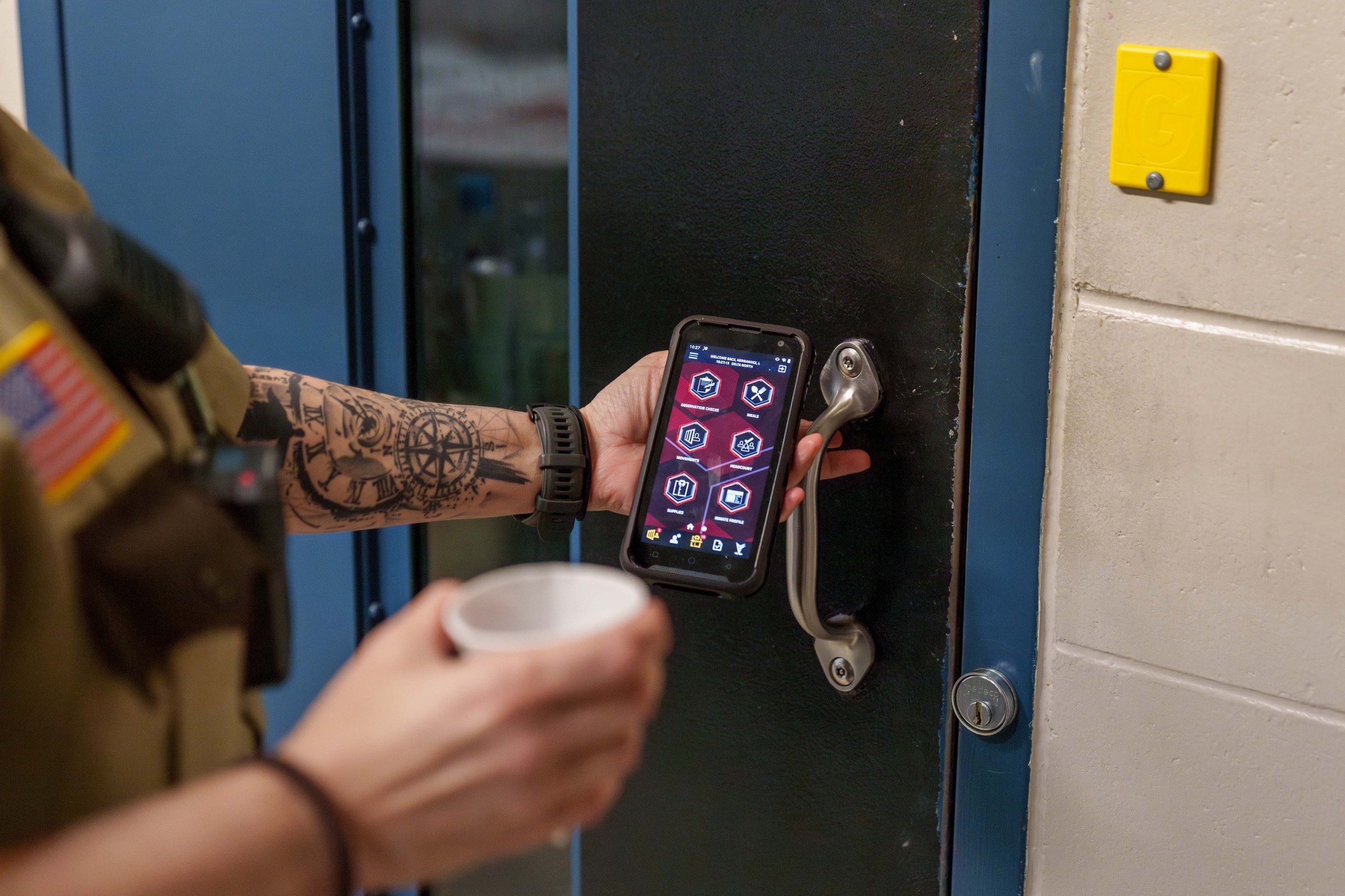 Corrections officer scanning a cell door with the GUARDIAN RFID mobile app during a cell check