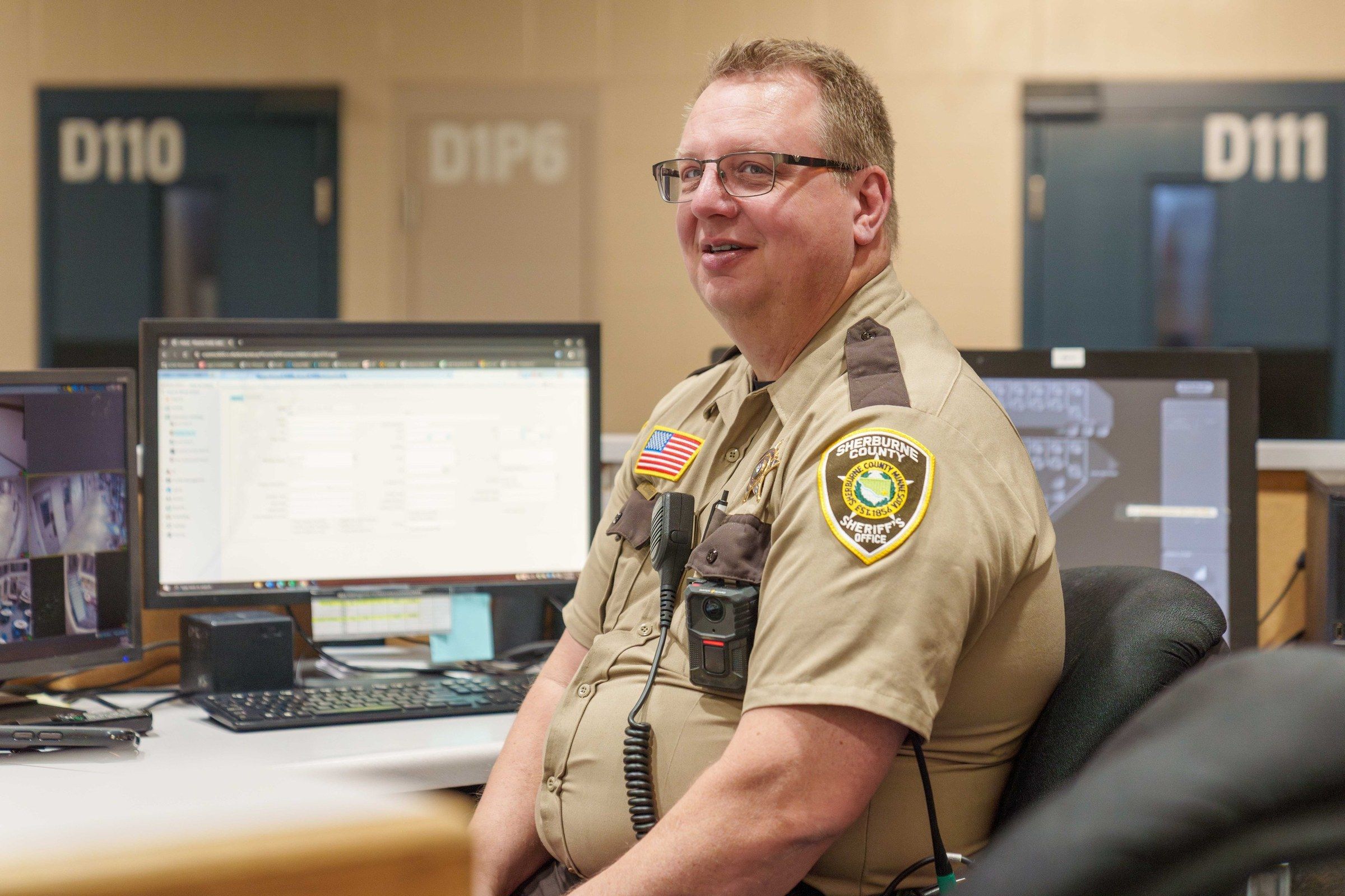 Corrections officer running GUARDIAN RFID at a jail master control room workstation