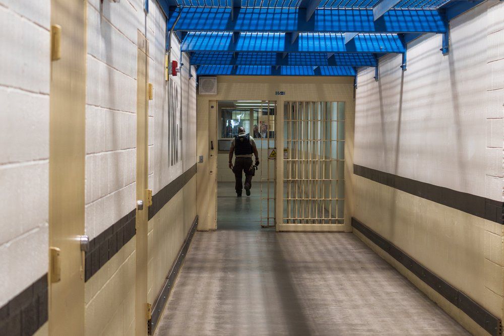 correctional officer walking through jail doors