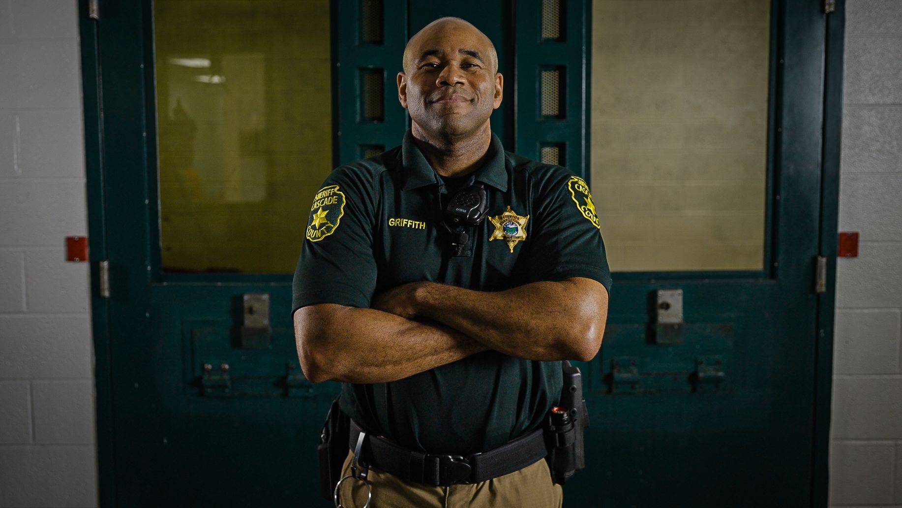 a correctional officer smiling at a jail