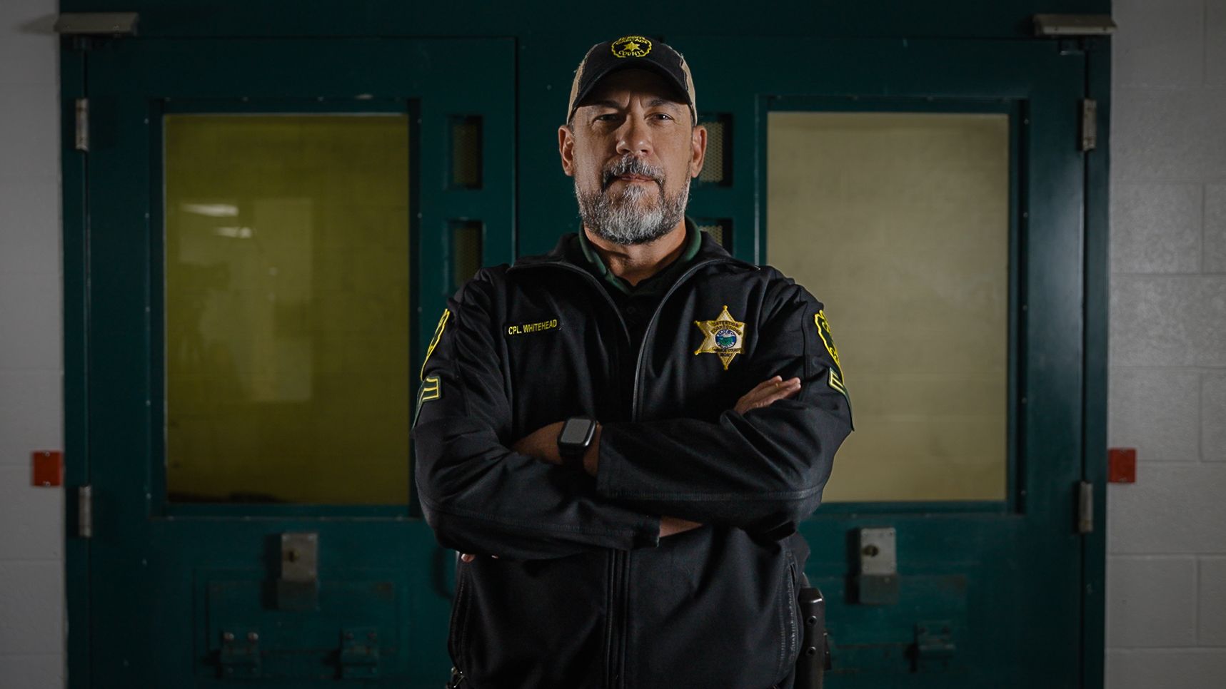 a corrections leader looks confident in front of a cell block