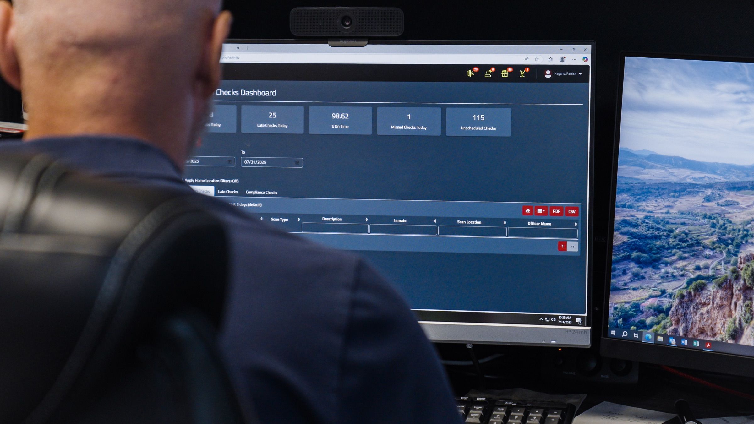 A corrections officer reviewing the GUARDIAN RFID Checks Dashboard on a control room monitor