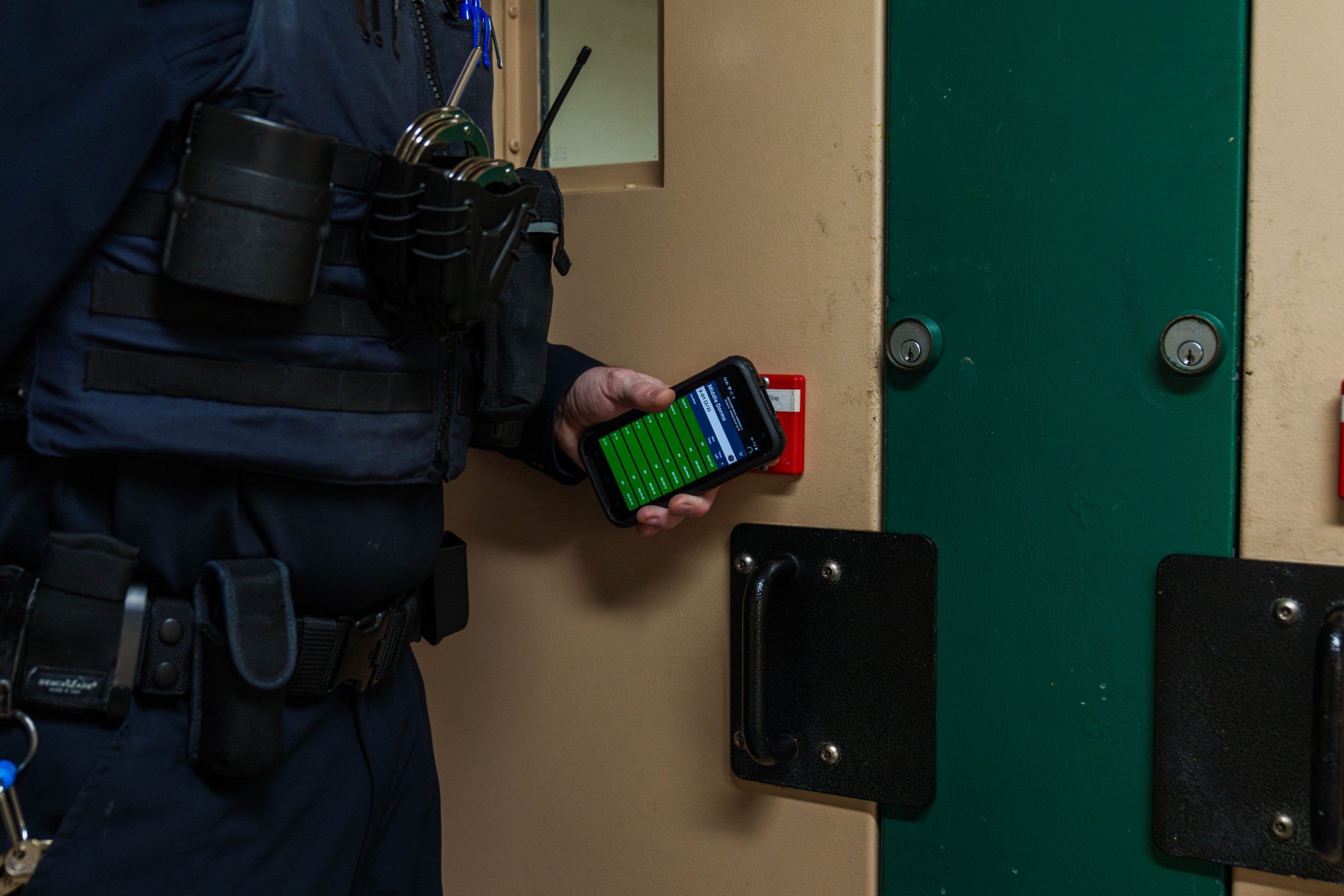 Officer scanning an RFID Hard Tag at a cell door