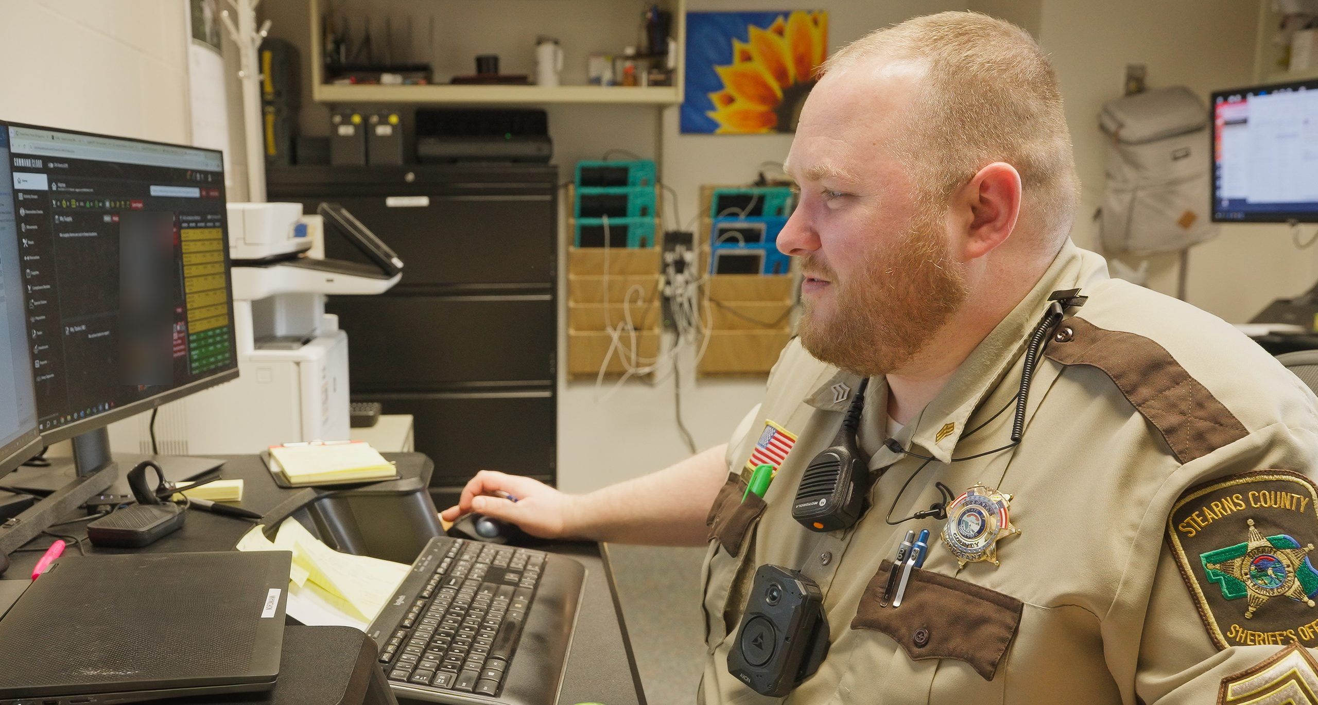 Corrections officer at a workstation with captured media in Mission Command