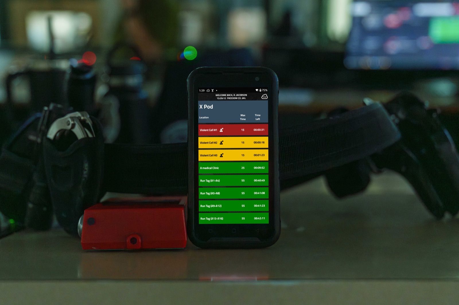 The Mobile Compliance Monitor timer screen on a SPARTAN handheld, with color-coded countdowns for each cell check and its location