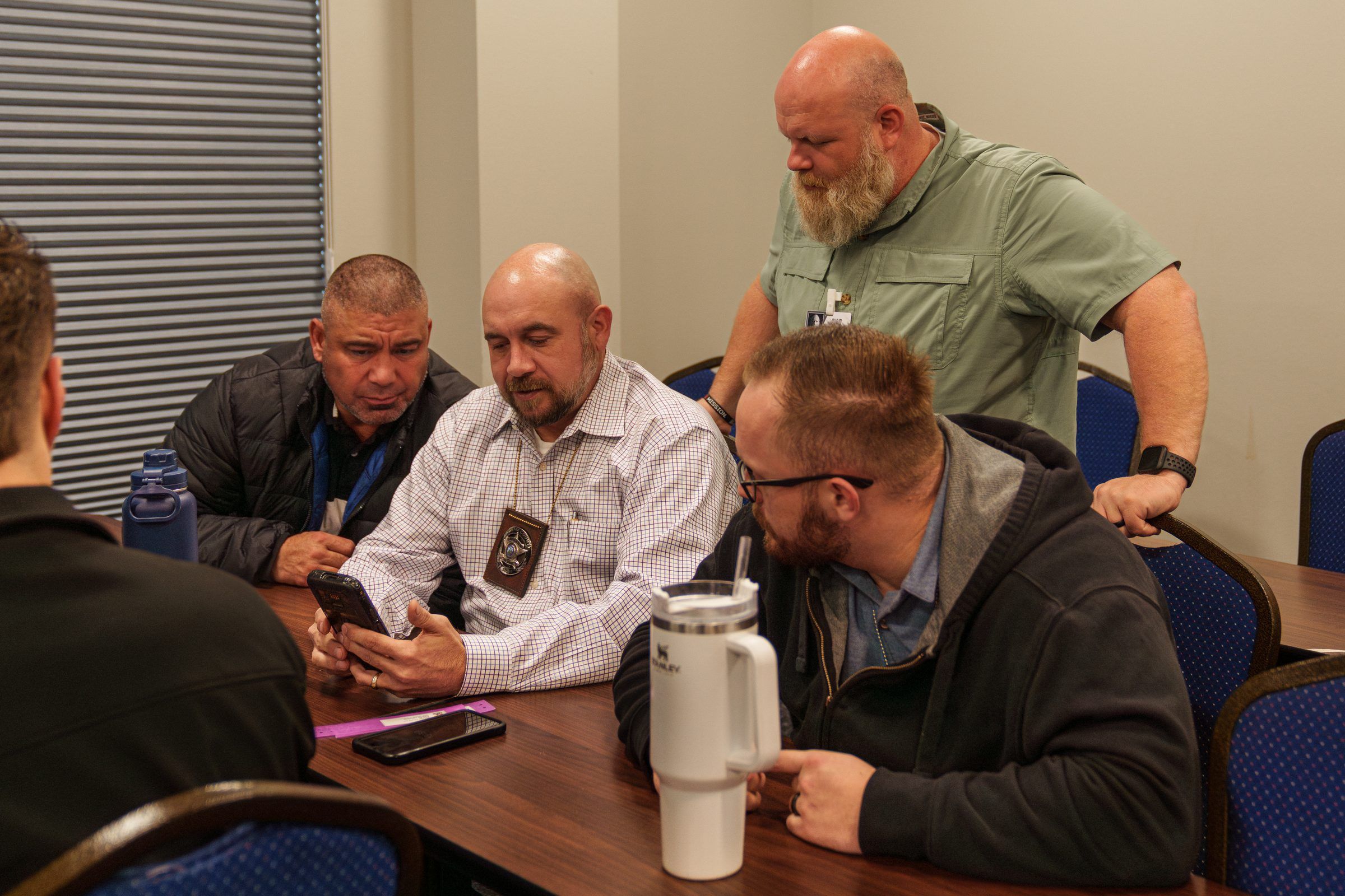 Correctional staff reviewing records together during GUARDIAN RFID training