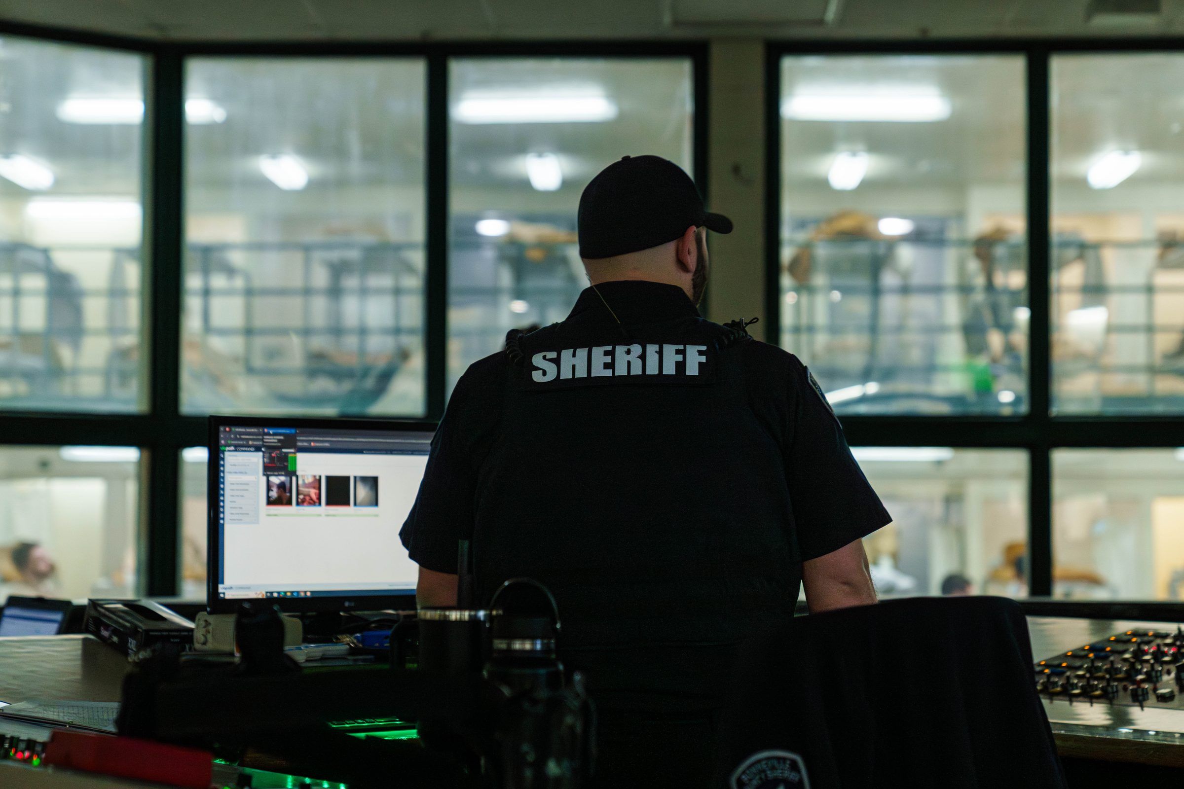 Corrections officer monitoring housing units in Command Cloud from the jail control room