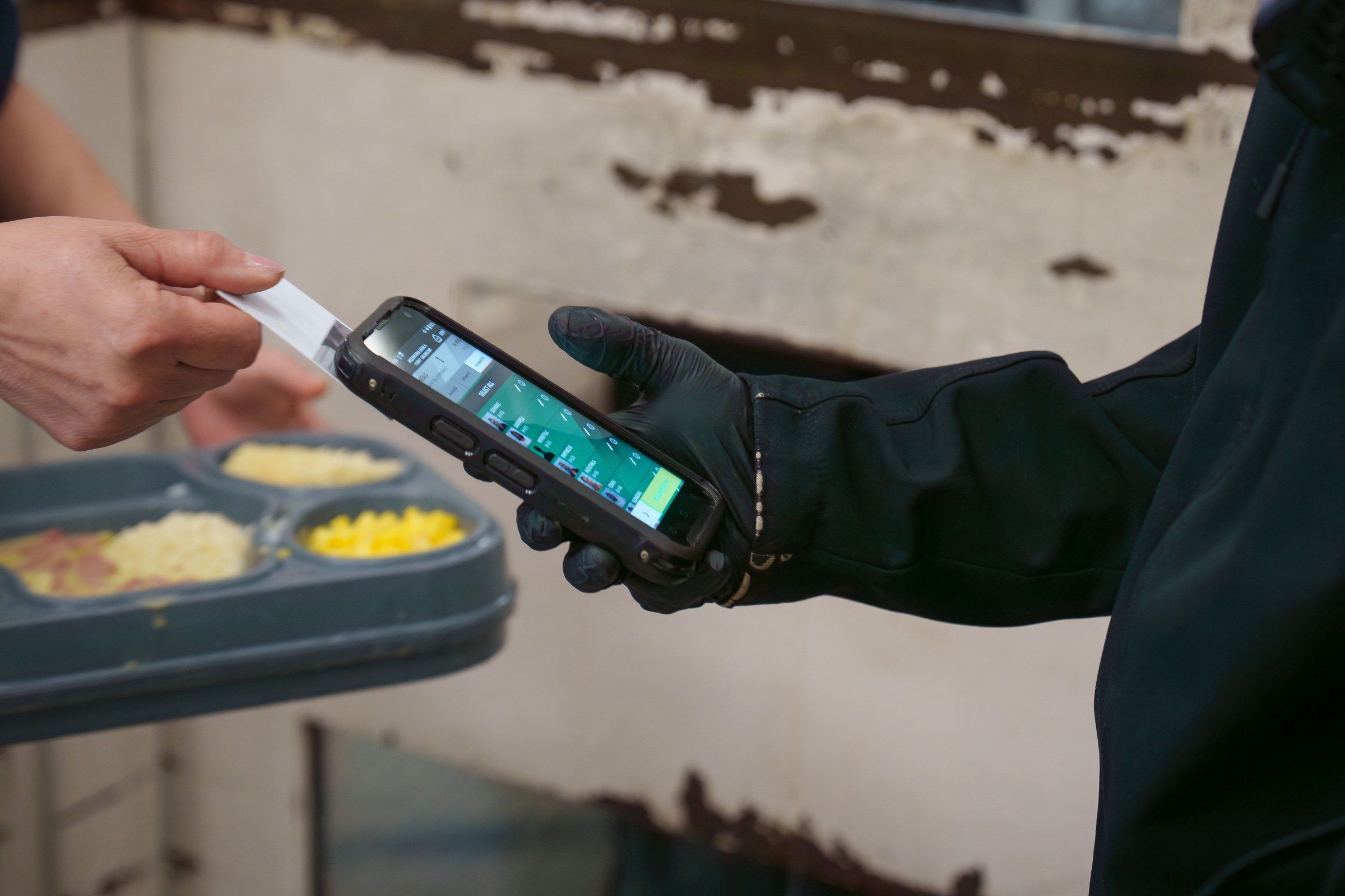 Officer scanning inmate ID cards at the meals module