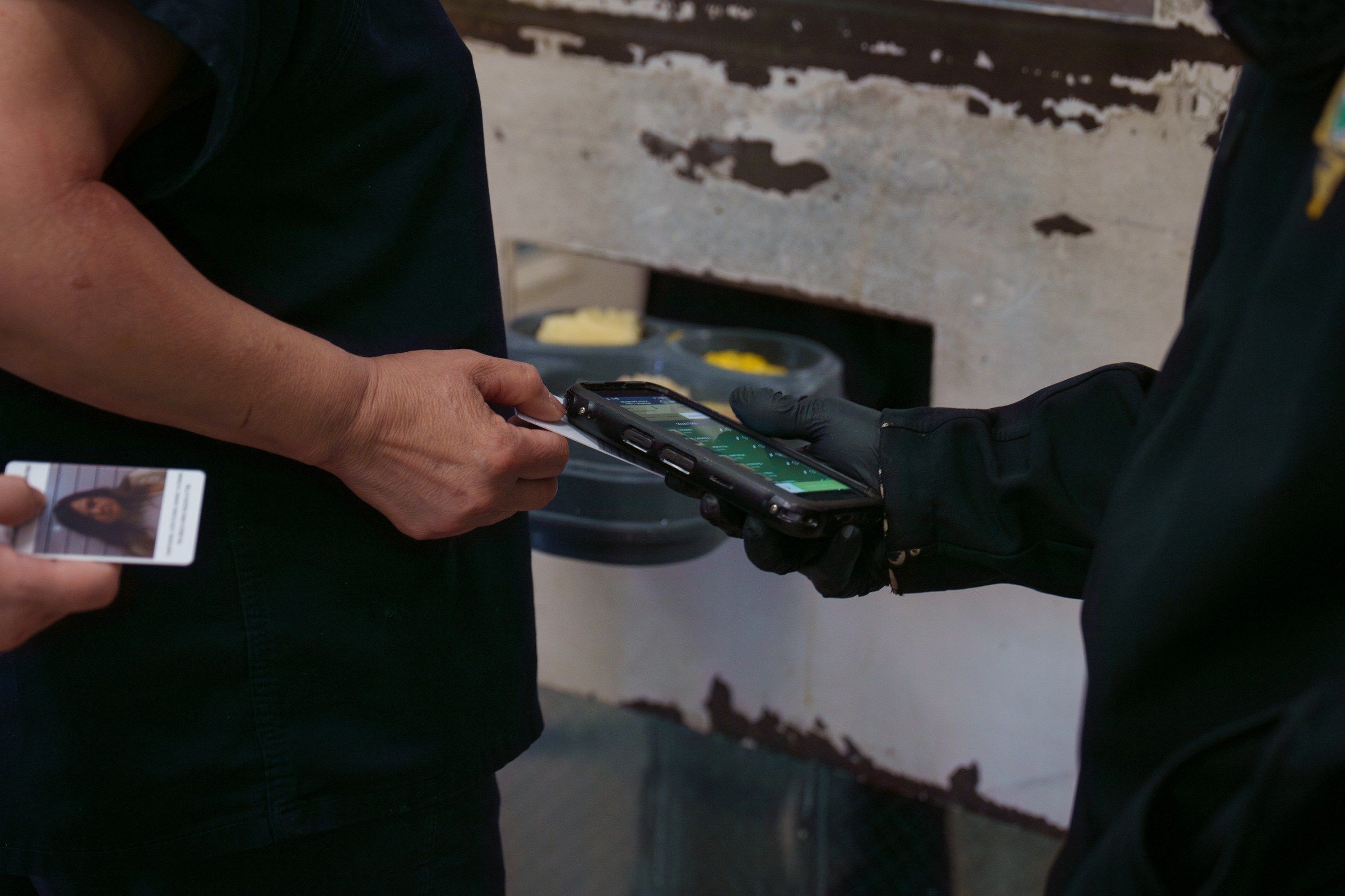 Officer scanning an inmate ID card during headcount