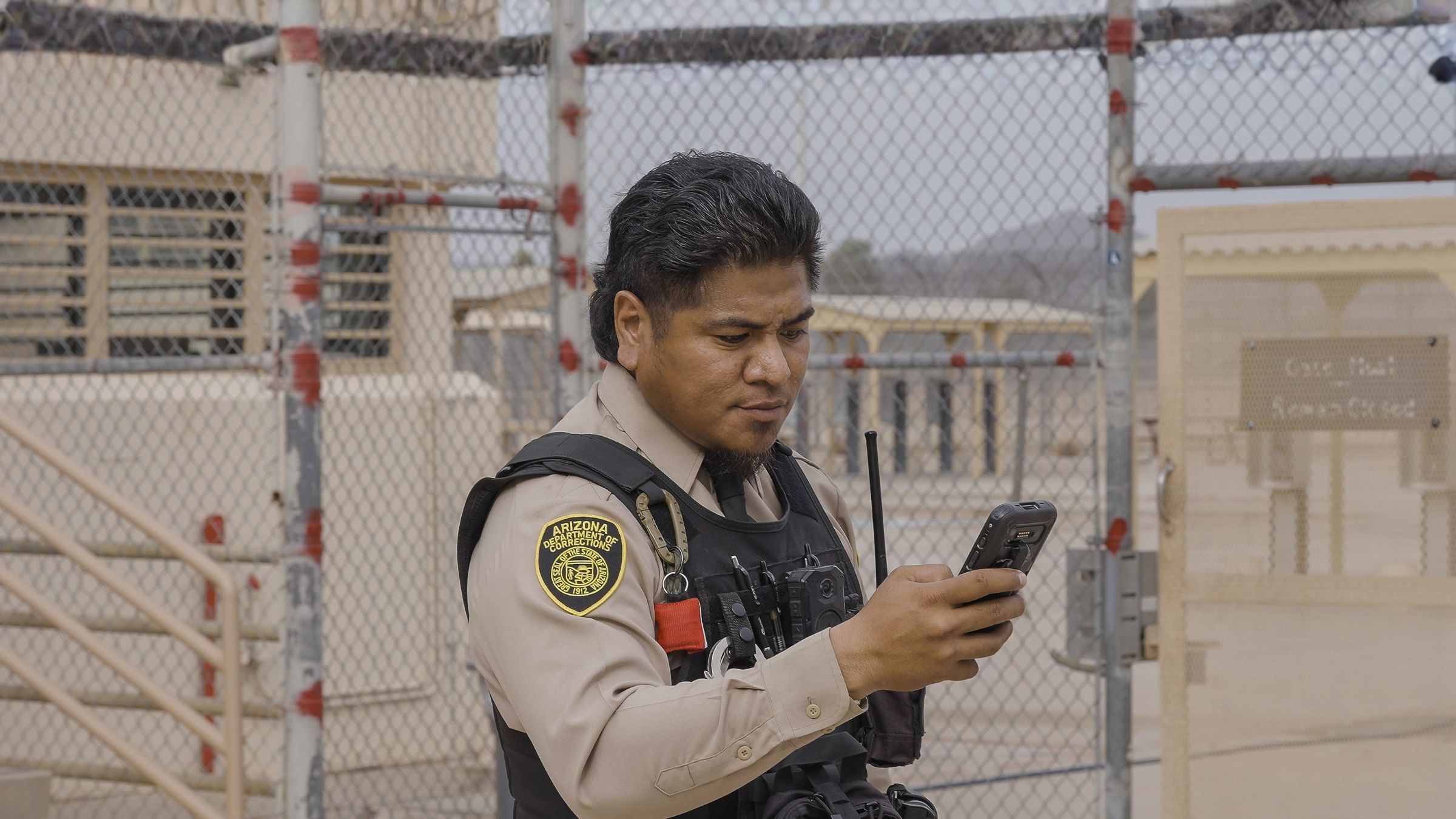 Officer using SPARTAN 3 at a facility perimeter gate