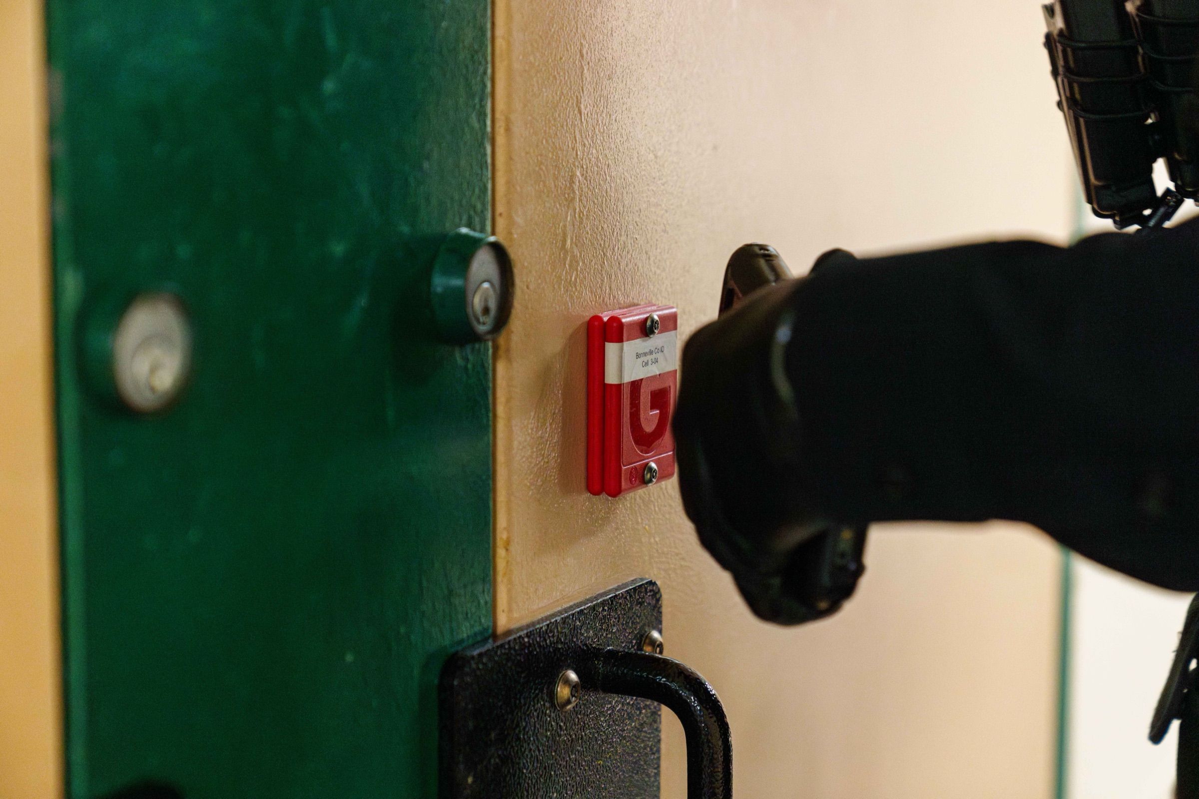 Officer scanning an RFID Hard Tag mounted beside a cell door